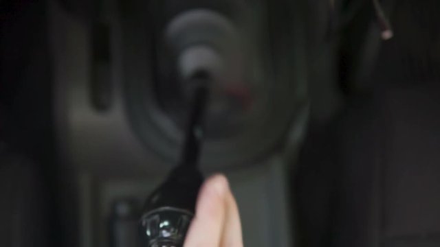 Man shifting and changing gears in stick shift car