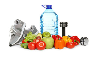 Healthy food, dumbbells and sneakers on white background. Concept of weight loss