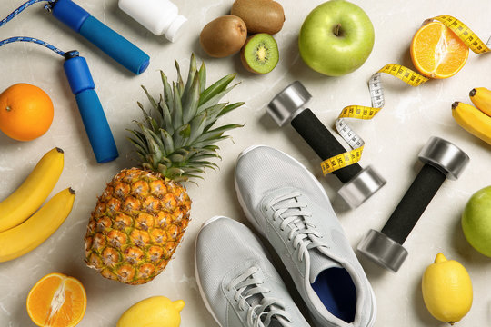 Flat Lay Composition With Sport Items And Healthy Food On Grey Background. Weight Loss Concept