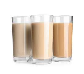 Glasses with protein shakes on white background