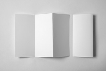 Blank brochure on white background, above view. Mock up for design