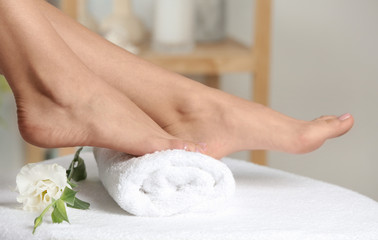 Obraz na płótnie Canvas Woman with smooth feet on white towel indoors, closeup. Spa treatment