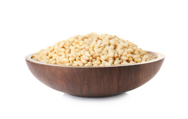 Plate with pine nuts on white background