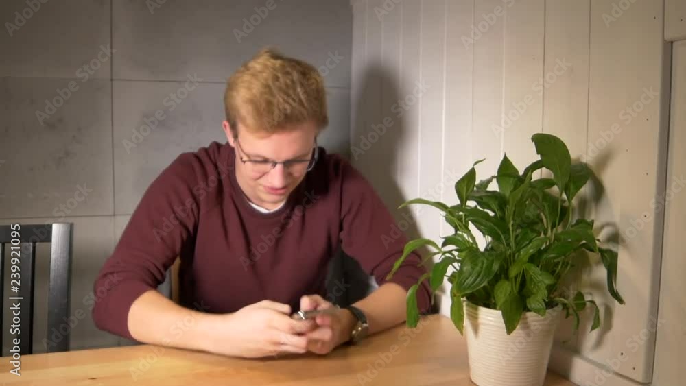 Aufkleber man intensely playing the mobile game. using smartphone vertically. losing the game