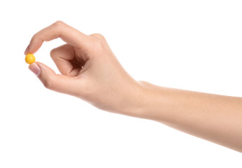 Woman holding color pill on white background, closeup