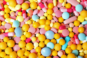 Heap of many different colorful pills as background