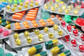 Heap of different pills in blister packs, closeup