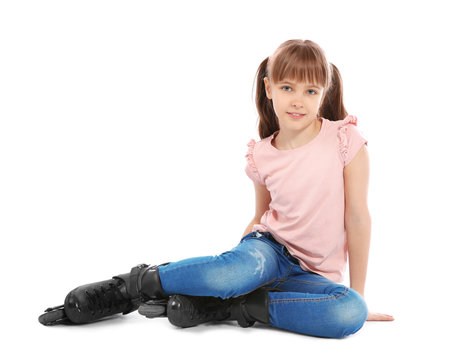 Girl with inline roller skates sitting on white background