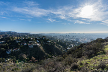 Clear morning view on canyon homes, Hollywood and downtown Los Angeles from hiking trail at Runyon Canyon Park.  