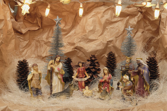 Nativity scene with colorful figurines of holy Mary Joseph Three Kings and animals symbolize Jesus place of birth Bethlehem crib