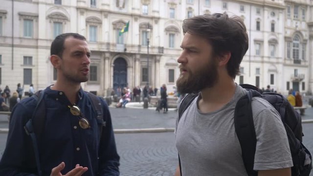 Uncertain Tourists In Rome Talking About Sightseeing.