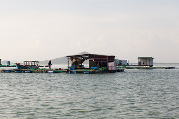 Fototapeta na wymiar Floating fisherman house on the sea in Vietnam