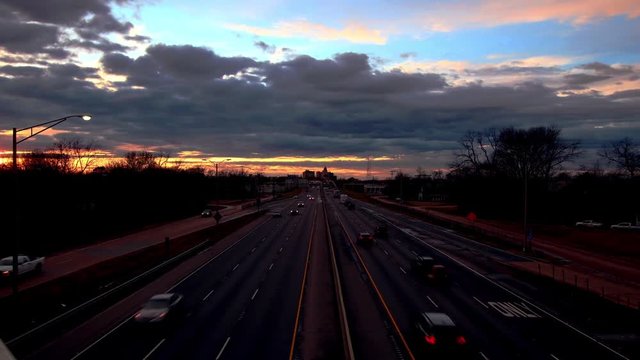 Time-Lapse of rush hour at sunset on the I-20 east/west corridor at Monroe, La. with the city skyline