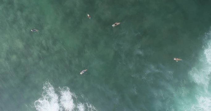 Aerial footage,Top view from drone of surfers paddling for catching waves during surfing in the indian ocean,4k
