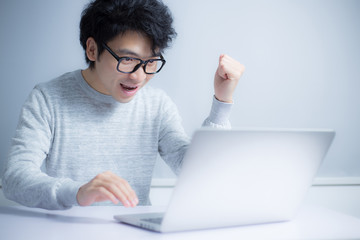Young Asian Man In Front Of Laptop