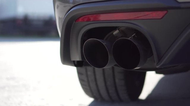 Close up of a car exhausttip. In the video you can see a double tip exhaust from a sports car v8.