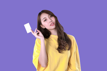 Korean woman use blank credit card to pay online shopping, yellow t-shirt clothing, purple background