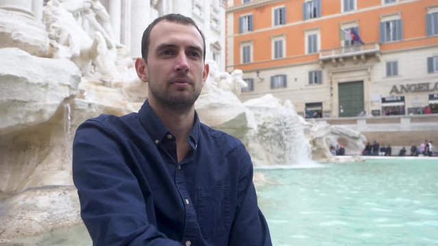 Millennial Sat Down Tossing Coin Into The Trevi Fountain.
