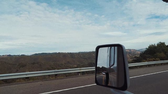 Drivers Side Window And Mirror From RV, Driving Down Empty Road On Central Cost Of California.