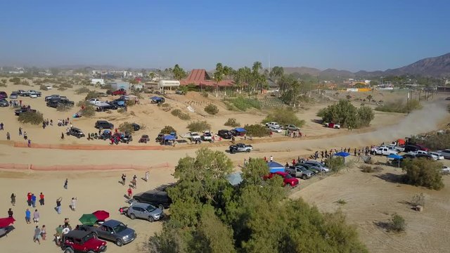 Aerial shot of the San Felipe 250 race. Trophy Truck races from right to left at high speed.
