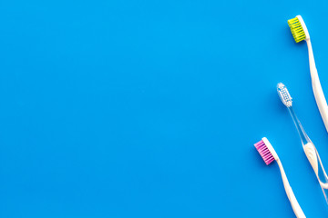 Tooth care with toothbrush. Set of cleaning products for teeth on blue background top view mockup