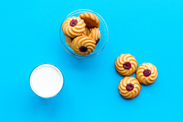 Children tradition evening dessert. Milk and homemade cookies on blue background top view