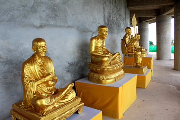 Golden statues of Buddhist abbots oround the base of THe Big Bhuddha, Phuket, Thailand.