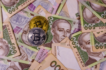 Bitcoin coins on the ukrainian five hundred hryvnas banknotes