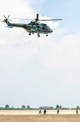 Fototapeta na wymiar Soldiers on a rescue military operation with helicopter.