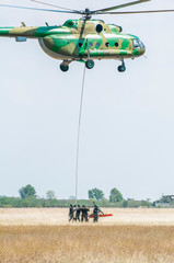 Soldiers on a rescue military operation with helicopter.