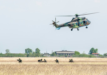 Soldiers on a rescue military operation with helicopter.