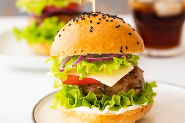 Delicious burgers with beef, tomato, cheese, french fries and lettuce. Copy space.