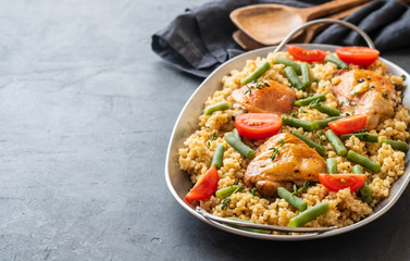 Grilled chicken thighs with bulgur, asparagus beans and tomatoes. Delicious lunch.