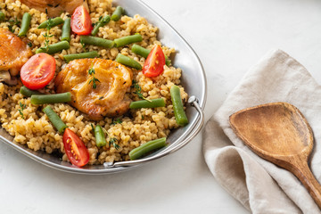 Grilled chicken thighs with bulgur, asparagus beans and tomatoes. Delicious lunch.