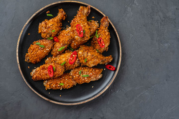 Chicken nuggets with sauce and pepper on a dark background. Copy space.