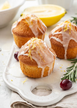 Muffins, cakes with cranberry and lemon on a white board.
