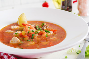 Brazilian food: Moqueca capixaba of fish and bell peppers in spicy coconut sauce  in a plate on a...