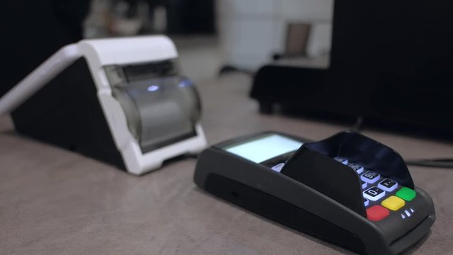 Smart terminal in operation. Online ticket office with a terminal. electronic cash register close-up. checkout. Mobile Payment with NFC technology on Smartphone shopping online.