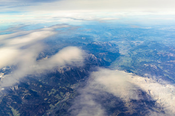 Blue sky and mountain landscape over Europe from an airplane window