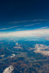 Fototapeta na wymiar Blue sky and mountain landscape over Europe from an airplane window