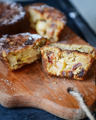 Homemade apple muffins with dates in a cut on a wooden background. Close-up, selective focus.