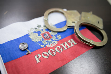 Russia flag  with handcuffs and a bundle of dollars. The concept of breaking the law and thieves...