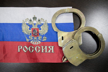Russia flag  with handcuffs and a bundle of dollars. The concept of breaking the law and thieves...