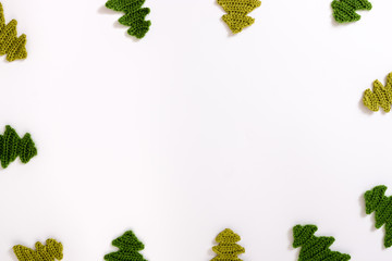 Christmas tree knitted from yarn on white background.