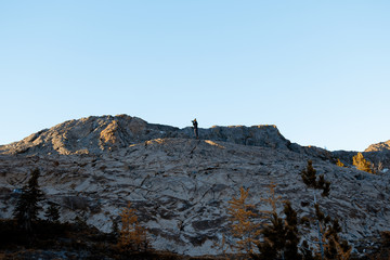 photographer shooting sunrise in the mountains 