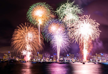 Beautiful fireworks shine on the sea with view of skyscrapers, Night sky with colorful fireworks above seascape, Pattaya, Thailand, Background for new year celebration with colorful fireworks 2019