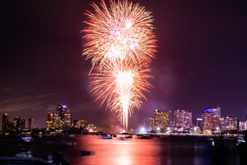 Beautiful fireworks shine on the sea with view of skyscrapers, Night sky with colorful fireworks...