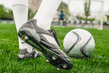 Soccer player with ball on a playing field