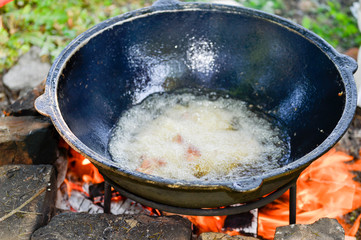 Roasting meat in a cauldron on vegetable oil in small portions to obtain a ruddy crust