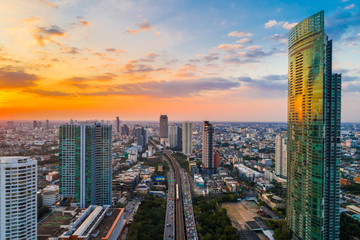 Sunset with modern building and transport city road aerial view